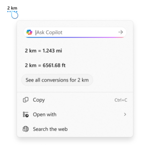 La herramienta de conversión de captura de pantalla muestra el uso de un ejemplo de 2 kilómetros. La conversión muestra kilómetros (1,243 millas) y tiene opciones para los pies (6561.68 pies), copiar, abrir o buscar la web.